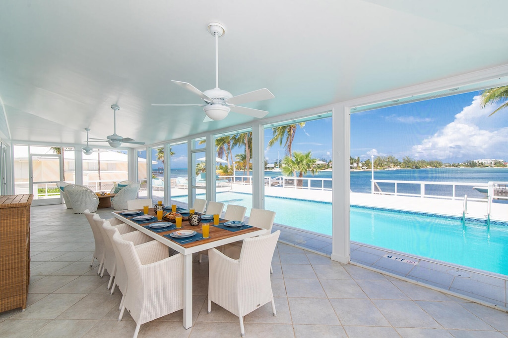 Screened patio dining overlooking the pool and cove.