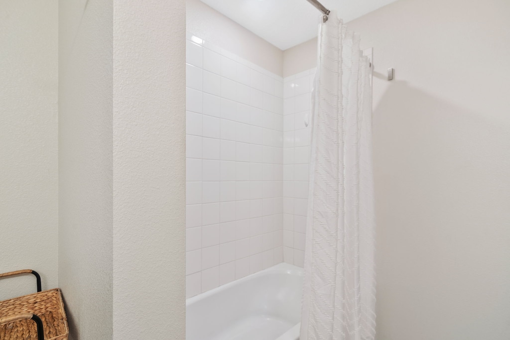 Bathroom 2 with a bathtub and a shower combo