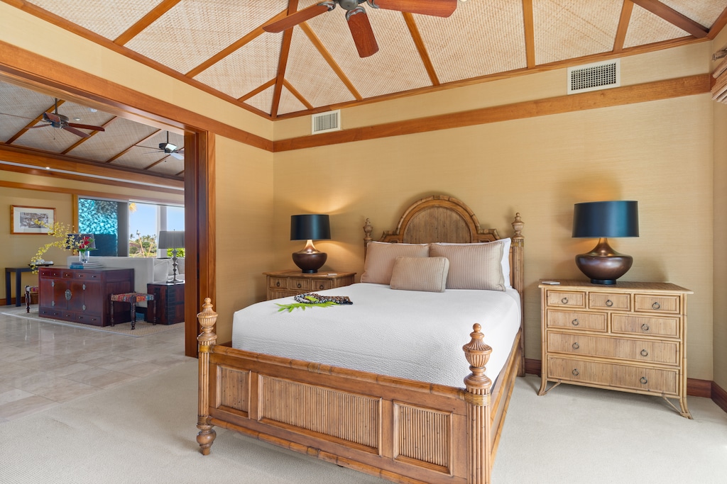 Second guest bedroom with warm island tones, king bed, and ample space for restful relaxation.