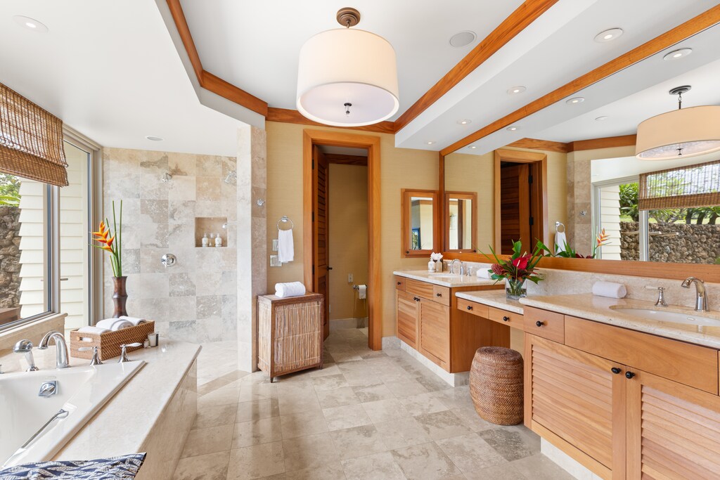 Spa-like primary bathroom with dual vanities, soaking tub, and walk-in shower—luxury and function combined.