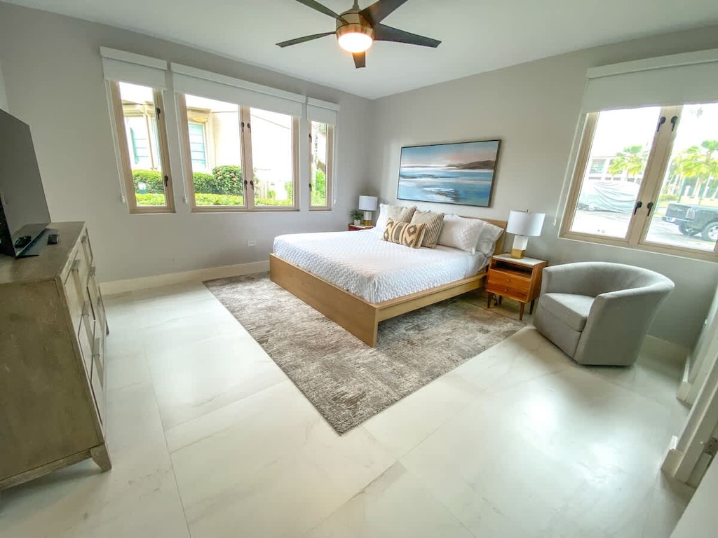 2nd Bedroom en suite: King Bed; Large windows make for a bright interior; comfortable armchair; TV atop and multi-draw credenza; A-C plus ceiling fan;
