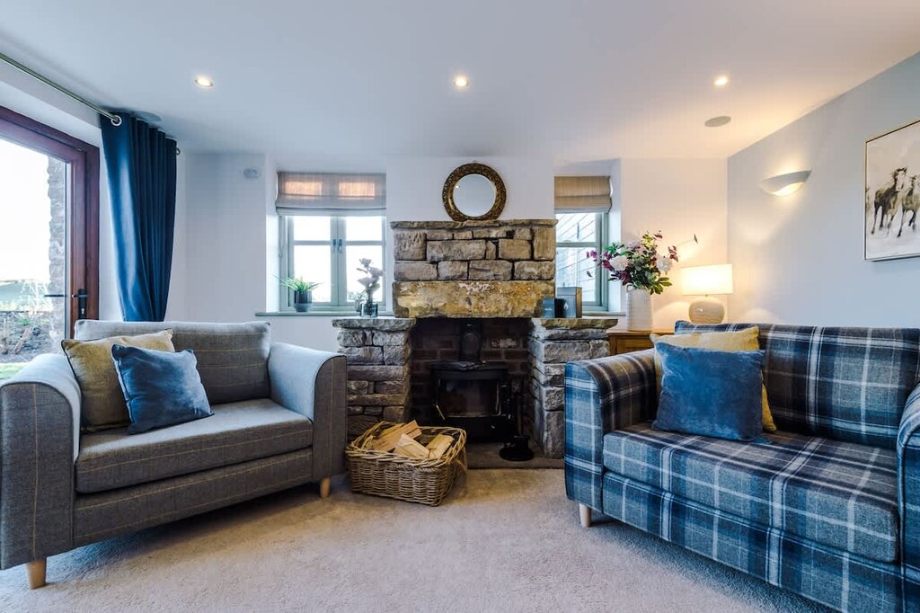 The spacious living room benefits from a 55-inch SMART TV with Netflix on the wall, plenty of space to sit down with family and friends in the evening, and a gorgeous log burner to keep warm in the evenings.