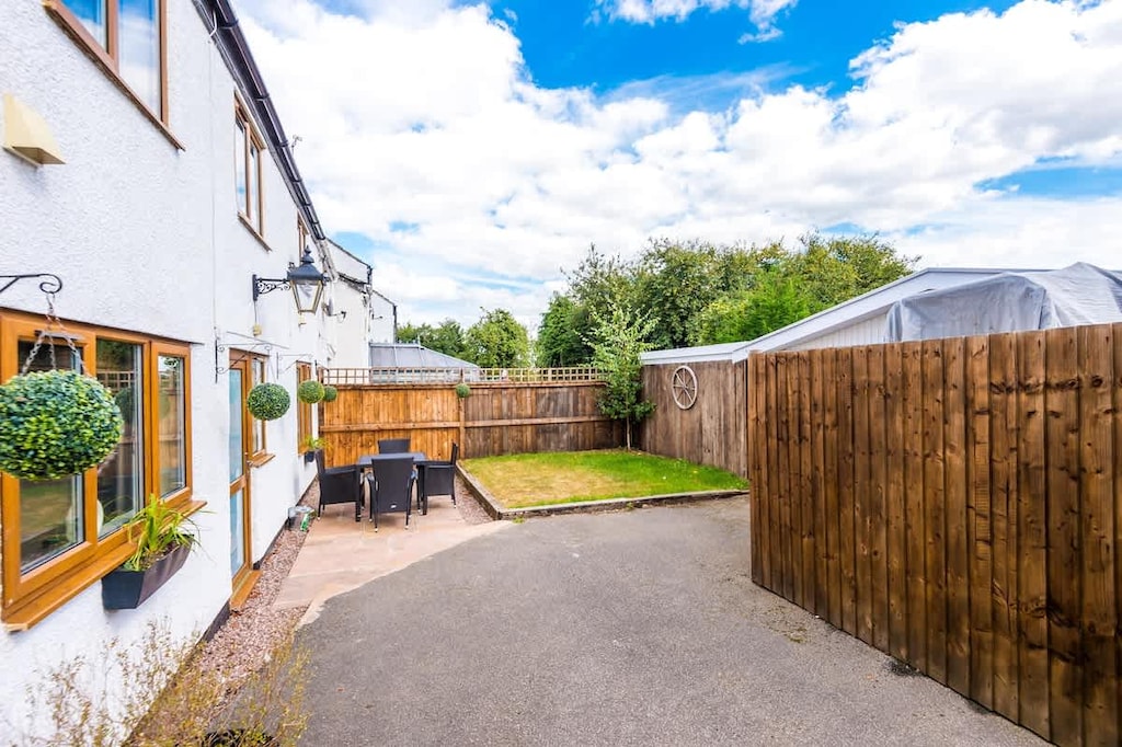 To the rear of the property, there is a patio with outdoor furniture, a small grass garden and ample parking.