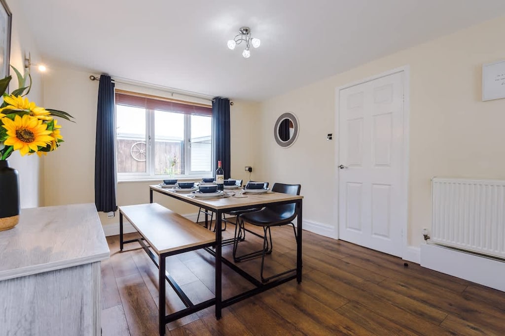 The dining room boasts a table that can comfortably sit 6 people with the option to seat 8 if necessary for larger groups.