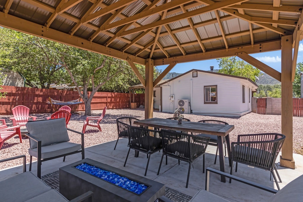 The home features a large outside living area, complete with a dining table and plenty of furniture so the entire group can relax outdoors in the shade.