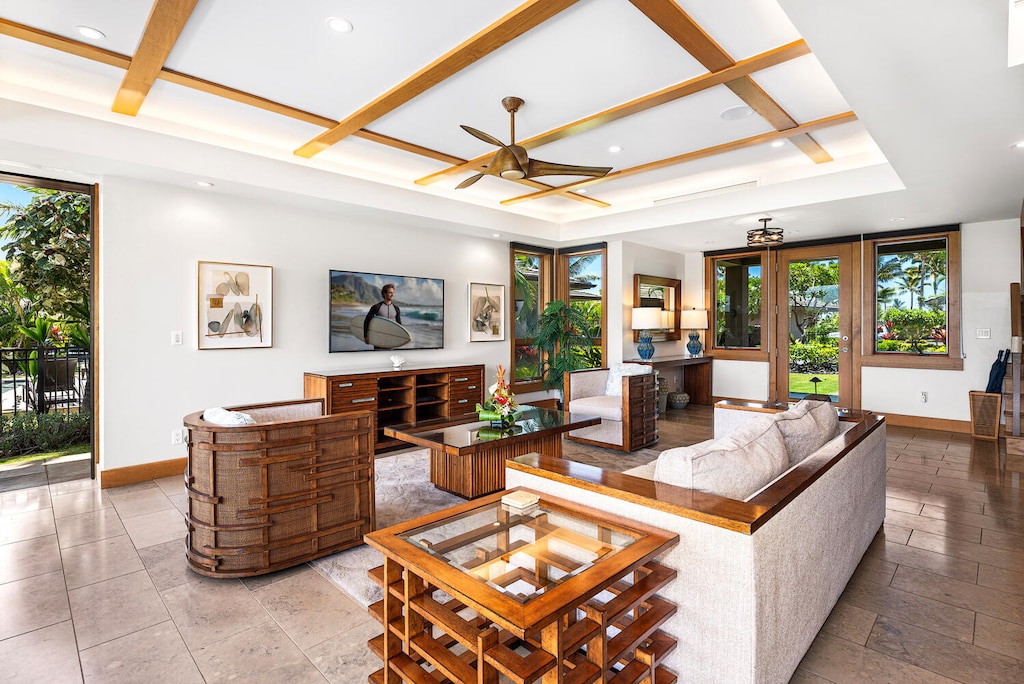 The living room is bright and airy with vaulted ceilings and garden views.