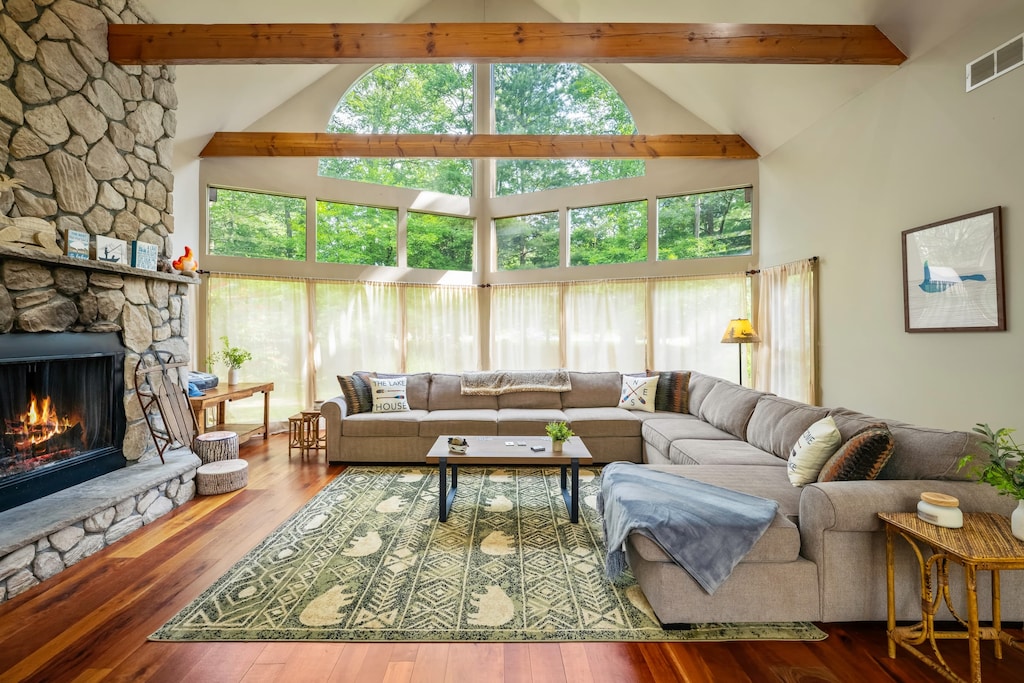 Cozy up on the large sectional in the living room, complete with a fireplace, high ceilings, and plenty of space to unwind.