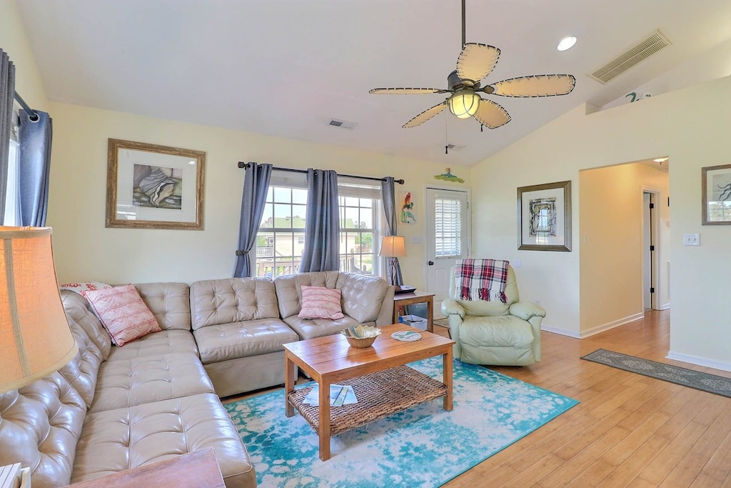 Soak in the bright and airy living space that includes plenty of comfortable furnishings, all centered around a flat-screen TV.