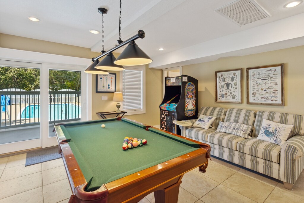 Let off some steam in the Game Room with Pub Table, Flat Screen TV, Pool Table, Full-Size Arcade Game, & Sofa!