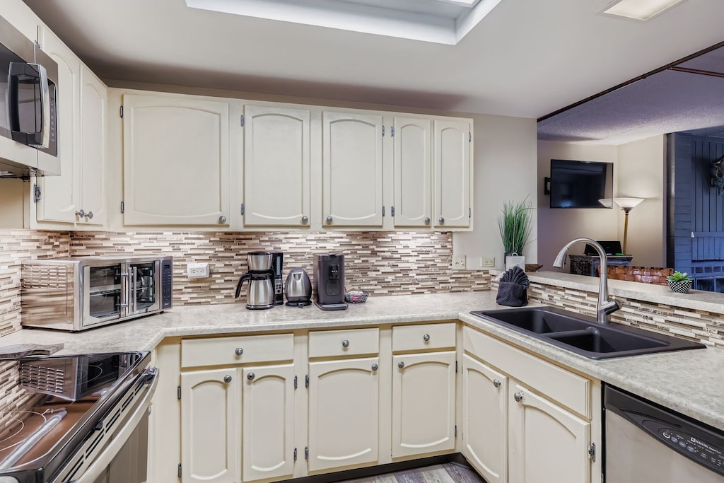 Bright and Functional Kitchen with Ample Cabinet Space and Modern Finishes.