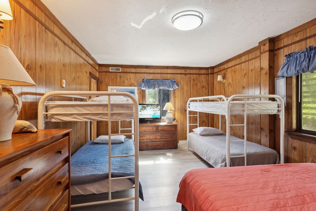 Relax in the Bedroom with a Queen Bed and 2 Bunk Bed Sets.