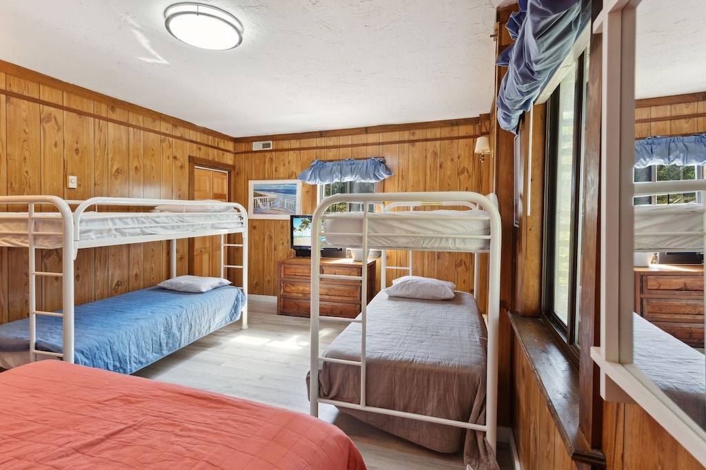 Relax in the Bedroom with a Queen Bed and 2 Bunk Bed Sets.