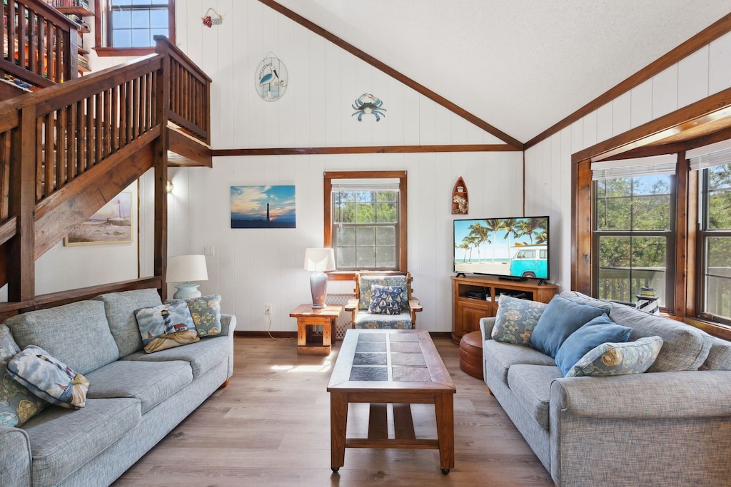 Relax in the spacious Living Area with a large, Flat Screen TV and lots of cozy furniture.