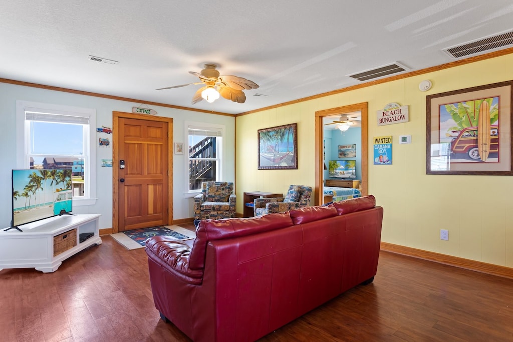 Relax in the spacious Living Area with wooden floors and a bright interior.