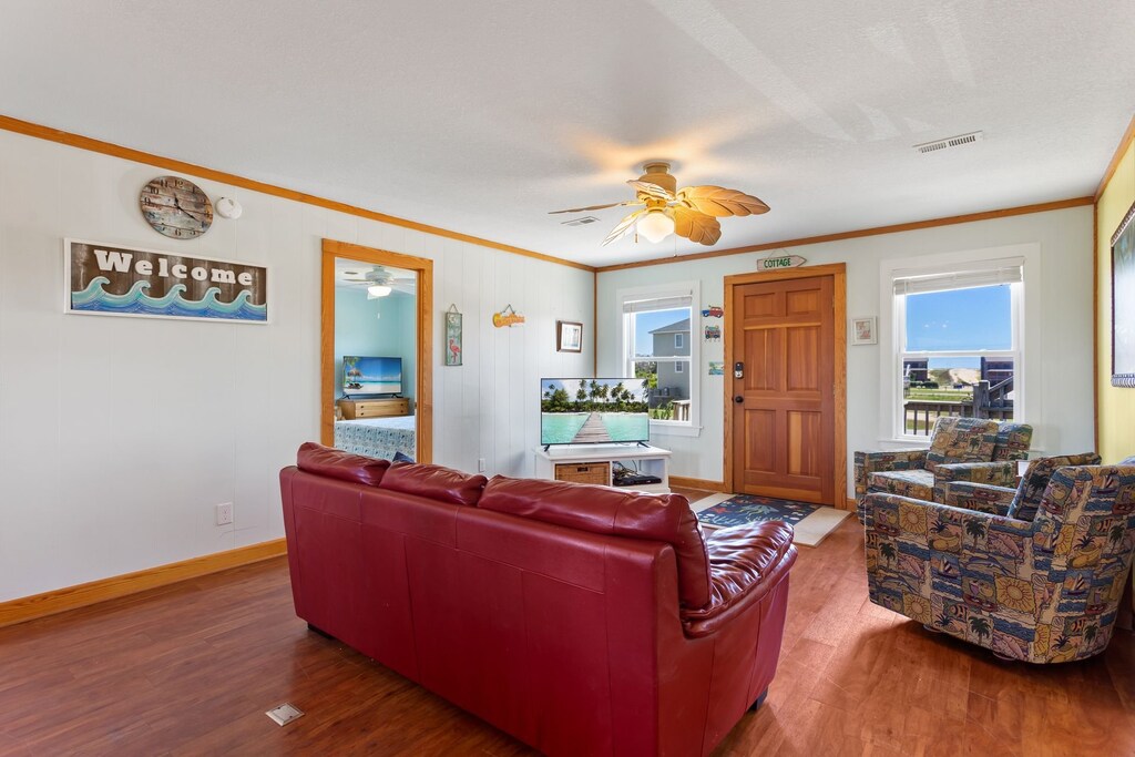 Relax in the spacious Living Area with wooden floors and a bright interior.