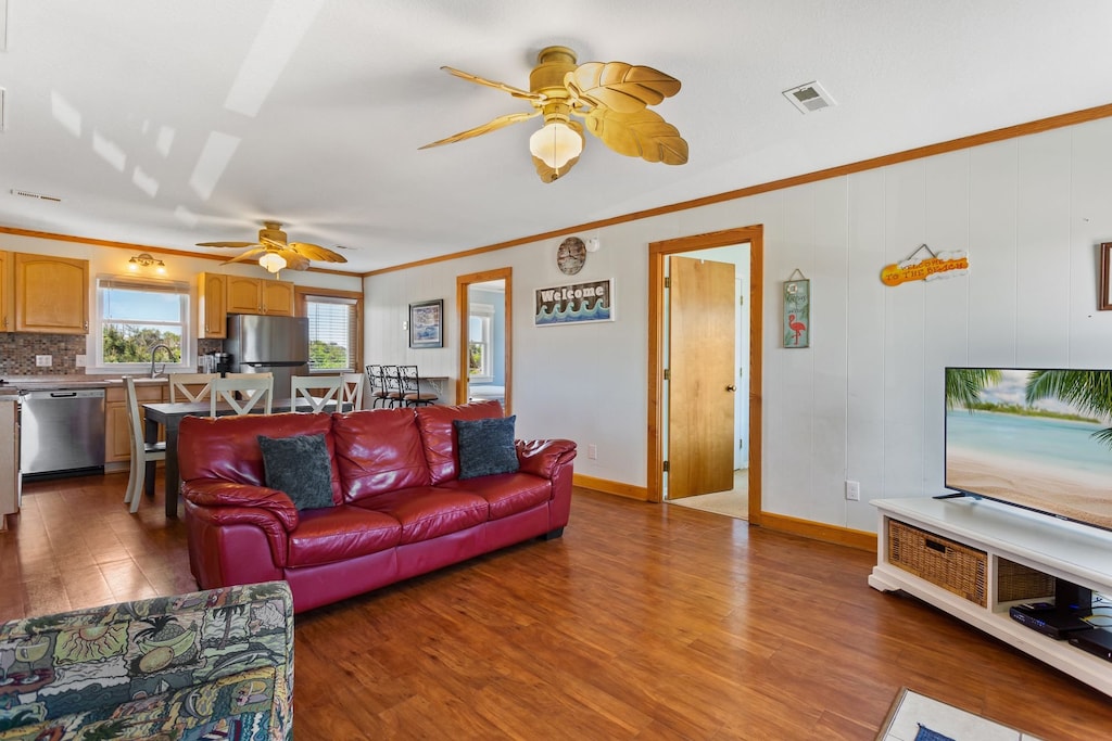 Relax in the spacious Living Area with wooden floors and a bright interior.