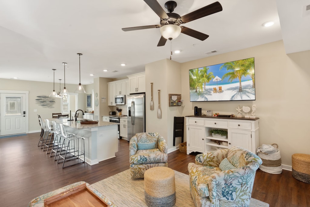 Spend your days in the spacious Living Area with beautiful high ceilings and lots of brilliant natural light coming in through the 12' sliding glass doors.