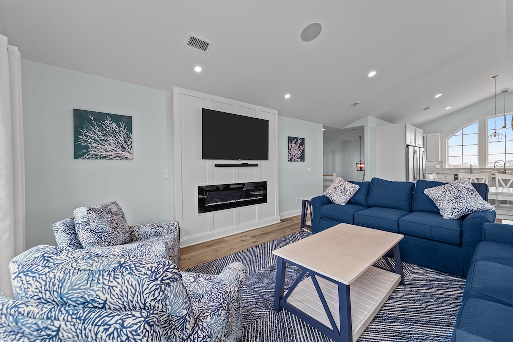 The Top Level is the perfect place to relax after a day exploring the Outer Banks, featuring an open-concept Living Area with an LED fireplace, where you can relax while gazing out over the tranquil sound.