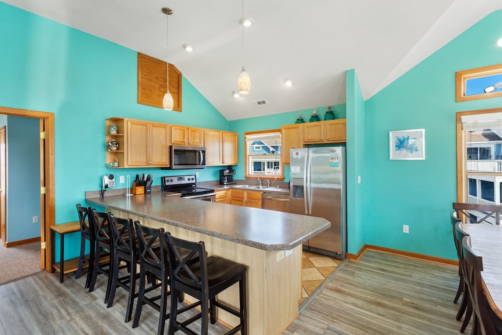 Whip up a quick meal in the neighboring fully-stocked open-concept Kitchen with stainless steel appliances and bar seating!