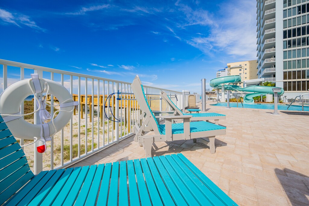 Relax by the pool with a slide, lounge chairs, and easy access to the beach for a perfect getaway experience