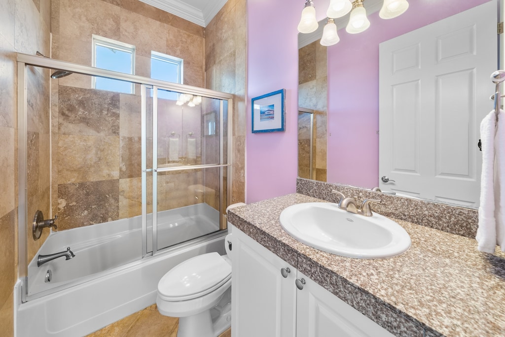 The 1st floor hallway bathroom sits next to the multi-twin bunk room, features a single vanity and shower/tub combo