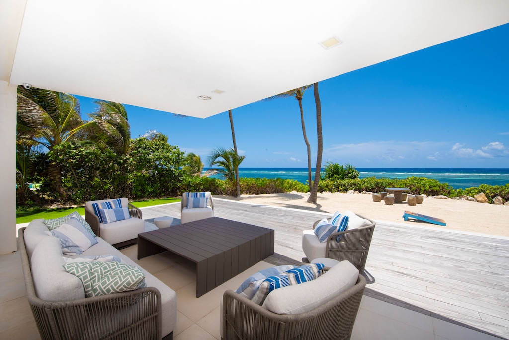 Lounge area under the veranda with forever blue ocean views.