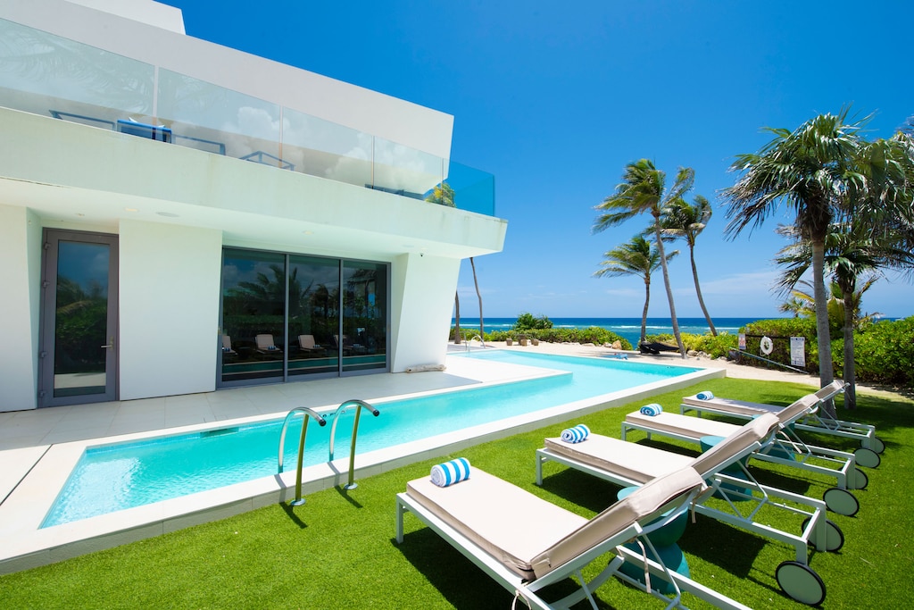 The home has a custom L-shaped pool that wraps around the side lawns of the backyard.