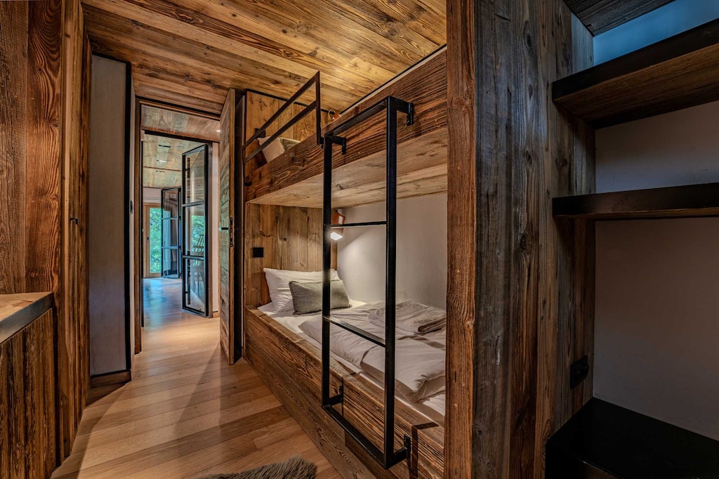 Charming alpine hallway with wood accents in Megève. This elegant entry welcomes you into a space where rustic design meets comfort, steps from the vibrant village center.