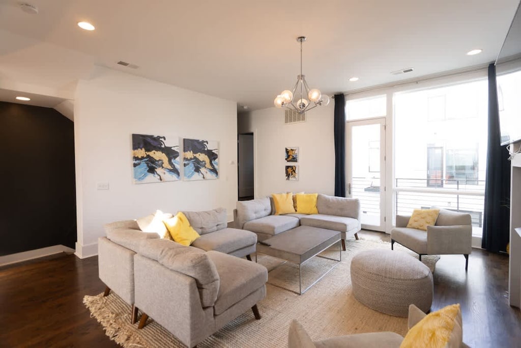 Living area with comfy seating, fireplace and large screen TV