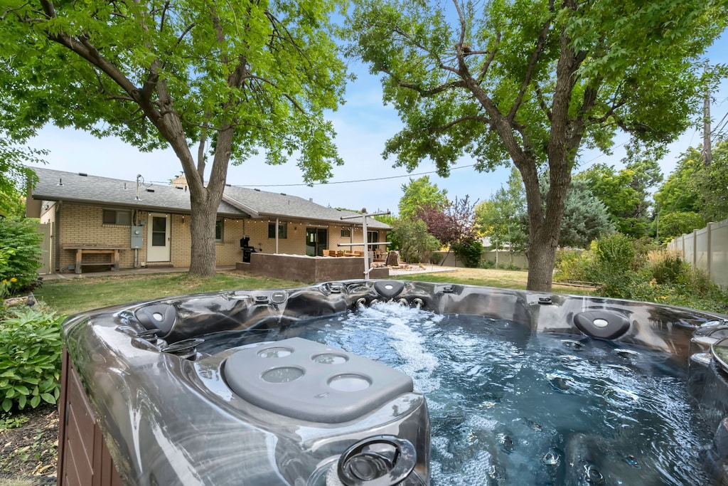 Backyard with Private Hot Tub, Lounge Seating, and Outdoor Dining Table