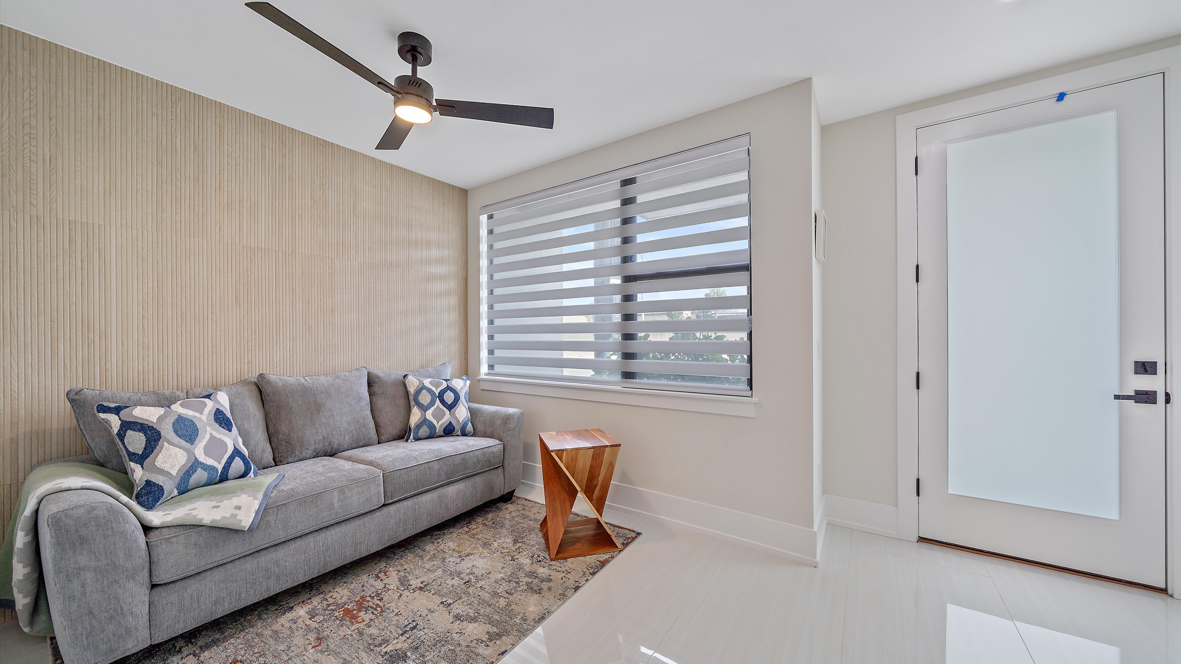 Private entryway features sitting area with sleeper sofa