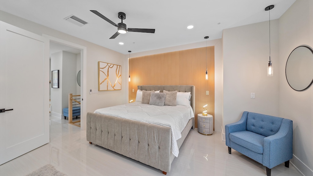 Wake up refreshed in this modern bedroom featuring a king bed with plush linens and a seating area