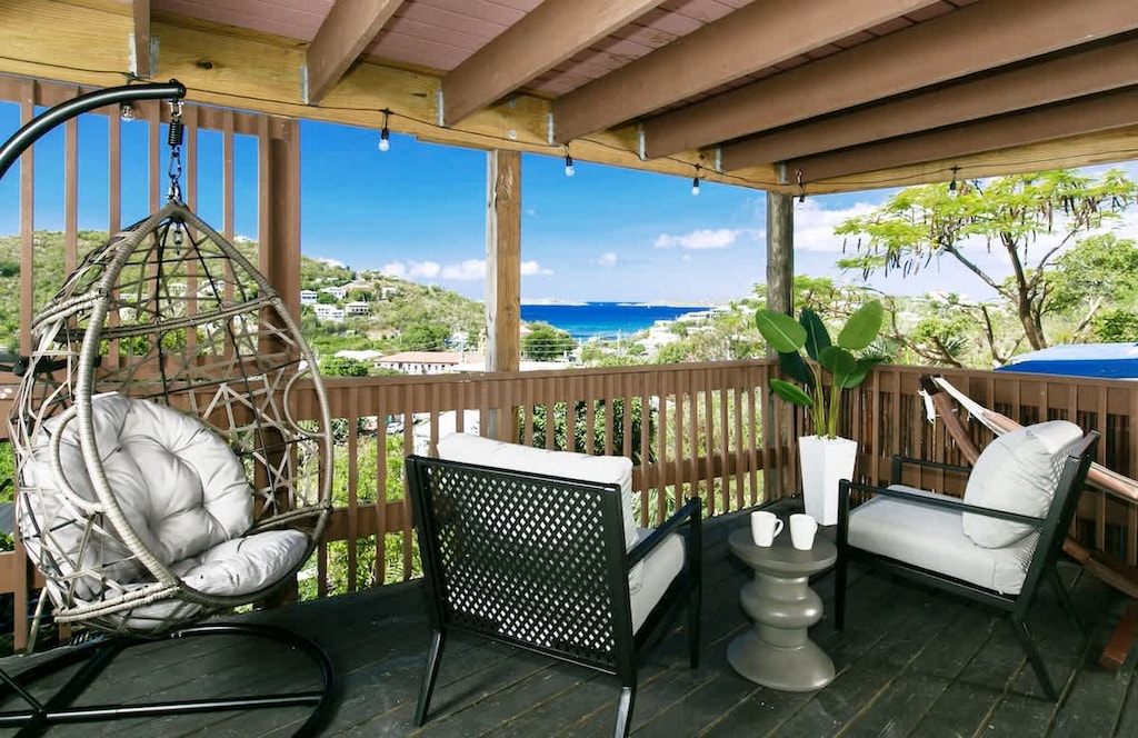 Relax on the deck with stunning ocean views and cozy seating. Perfect for a serene island getaway!