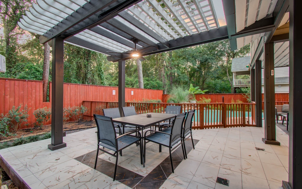 Fully furnished with outdoor dining furniture and a pergola with an overhead fan, this patio is perfect for enjoying an al fresco meal outdoors!
