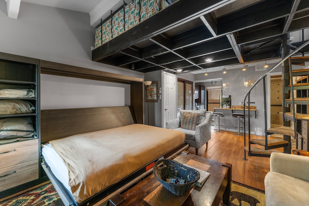 Living area with flat screen TV, fireplace, and queen sized murphy bed