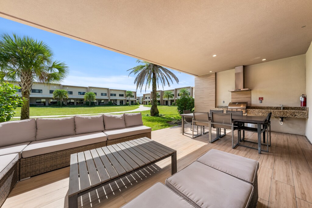 Relax in style with a cozy outdoor living area, with BBQ grill, perfect for family cookouts and evening gatherings under the Florida sky.