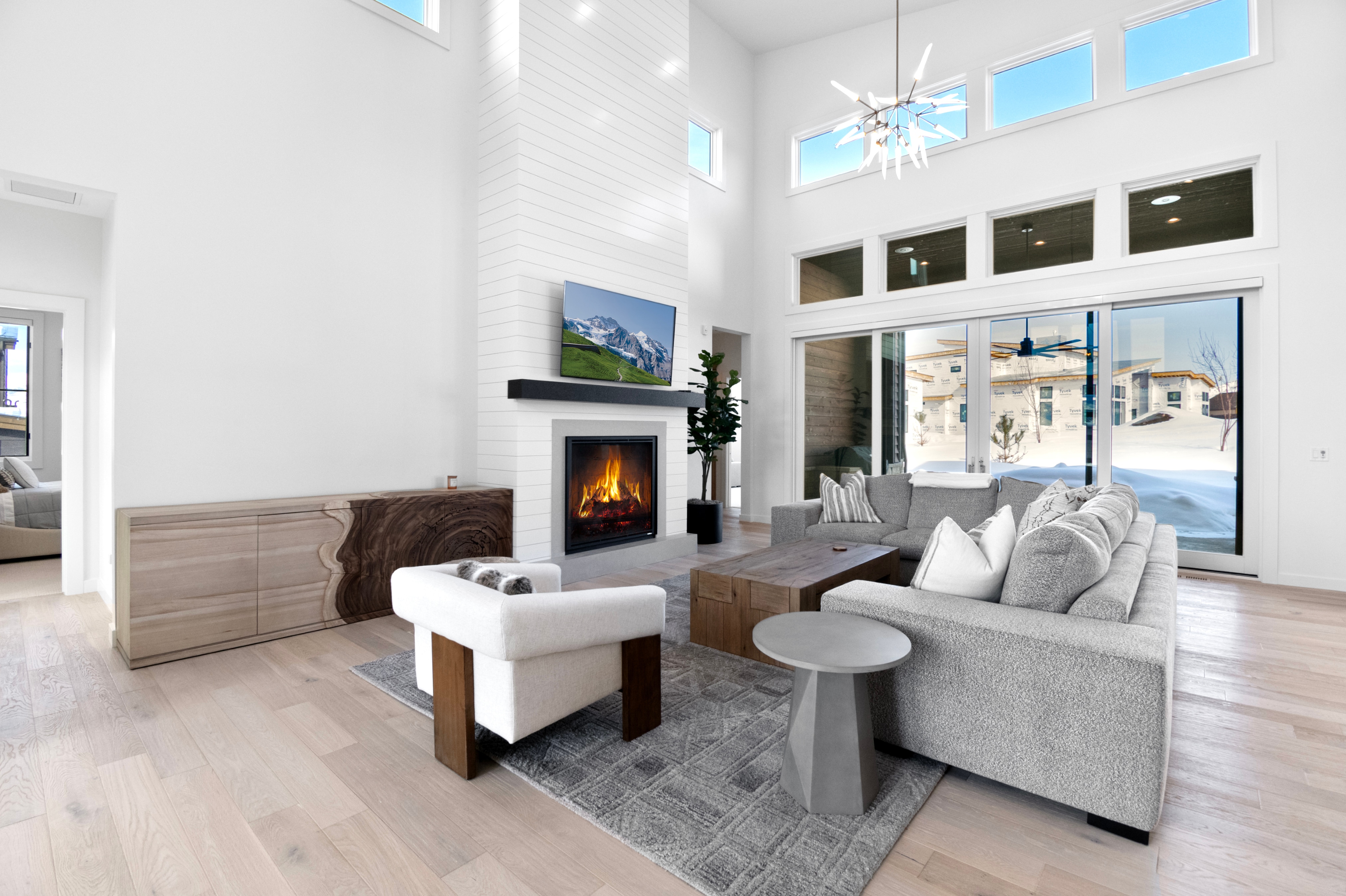 Bright and Sunny Living Room with custom furnishings, flat screen TV, Gas Fireplace in an Open Concept