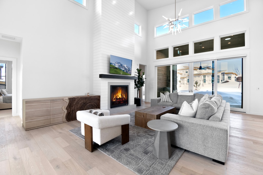 Bright and Sunny Living Room with custom furnishings, flat screen TV, Gas Fireplace in an Open Concept