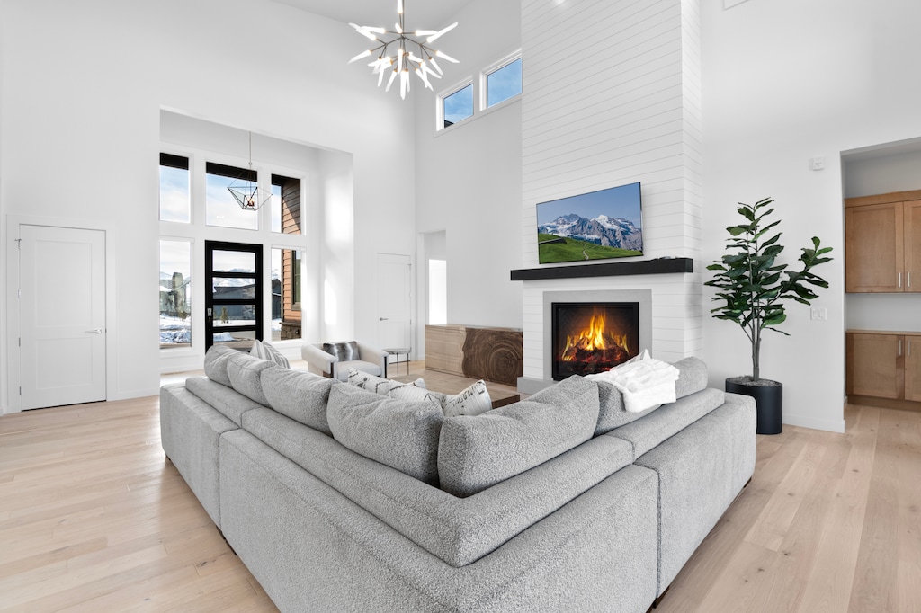 Bright and Sunny Living Room with custom furnishings, flat screen TV, Gas Fireplace in an Open Concept
