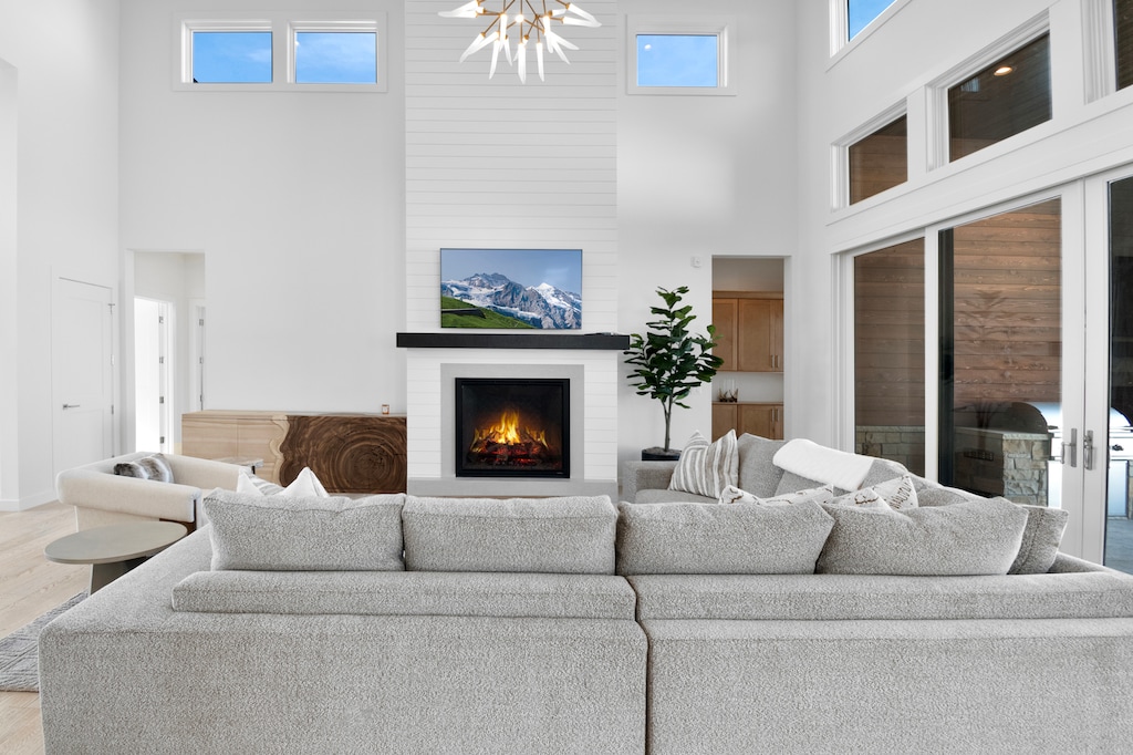 Bright and Sunny Living Room with custom furnishings, flat screen TV, Gas Fireplace in an Open Concept
