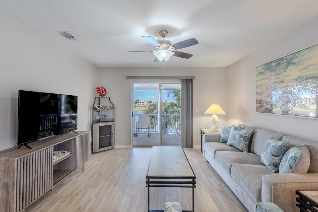 Bright open living room with lake views.