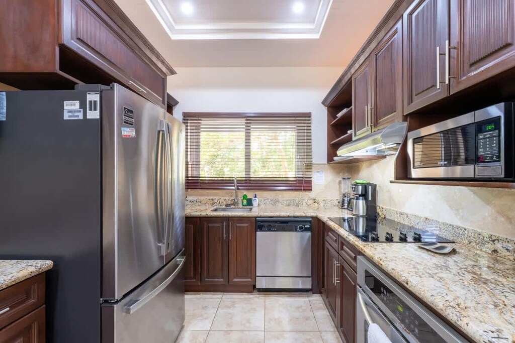 Open kitchen, stainless steel appliances.