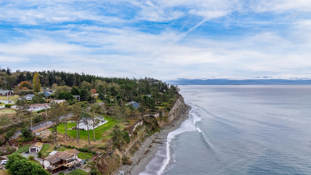 Aerial view showing home and coastline below.