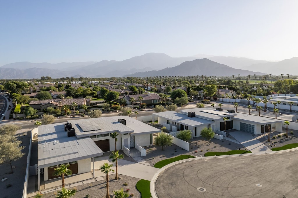 Panoramic view of the neighborhood and the beautiful mountain range, highlighting the tranquil, resort-like setting.