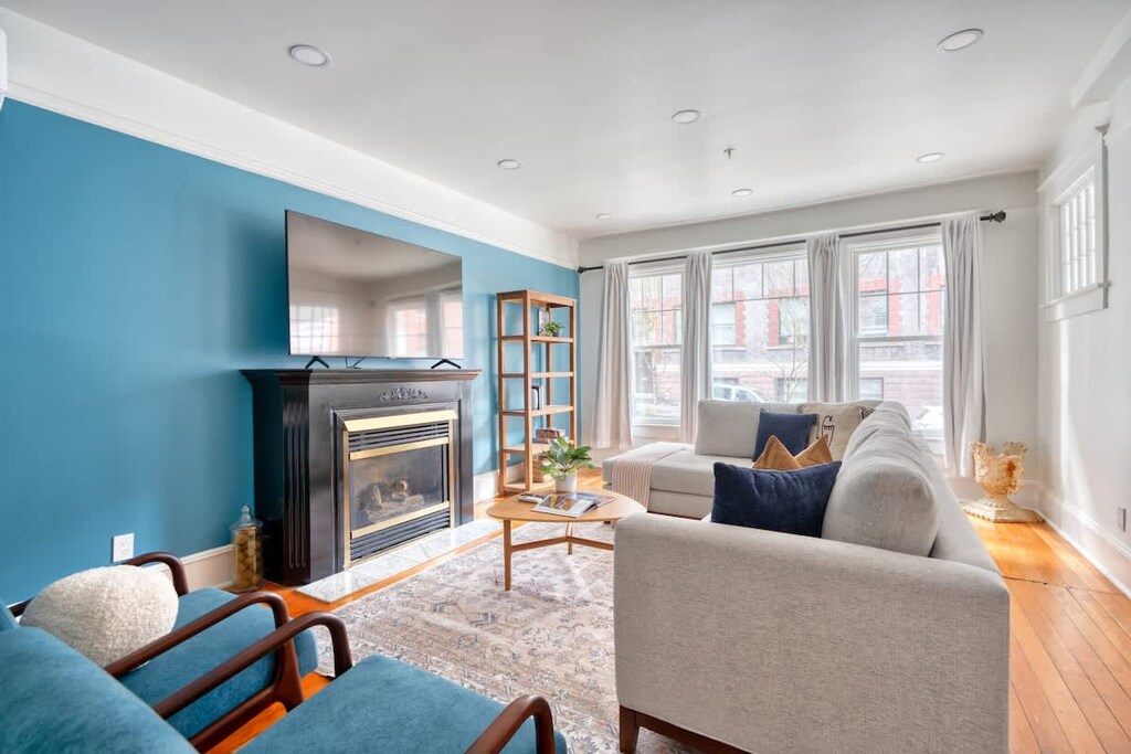 Living room with blue sofa and fireplace detail.