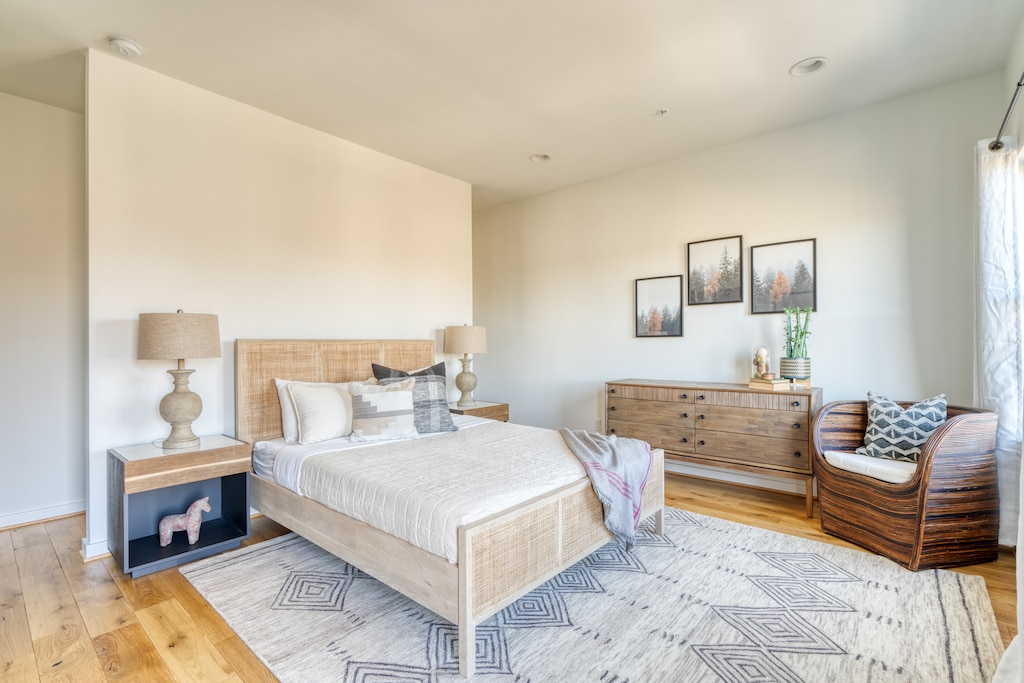 Bedroom with bed, nightstands and a chair.