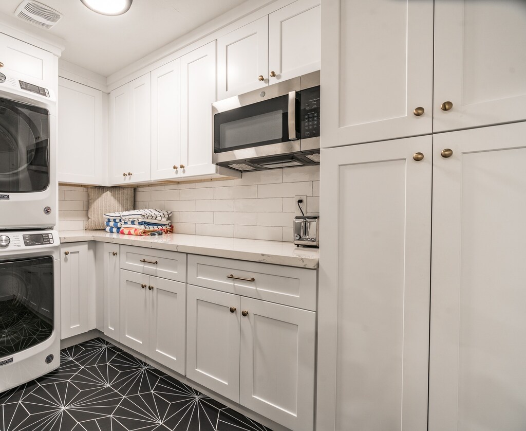 Laundry room with microwave and pantry with plenty of extra storage