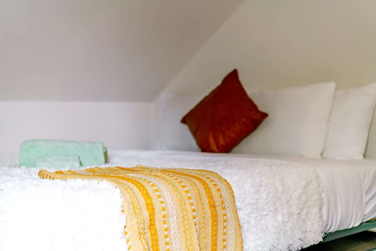 Let the soft sheets and serene colors of this room wrap around you as you settle in for the night. It’s the space where the weight of the day lifts away, leaving only comfort, warmth, and the promise of a restorative night’s sleep.