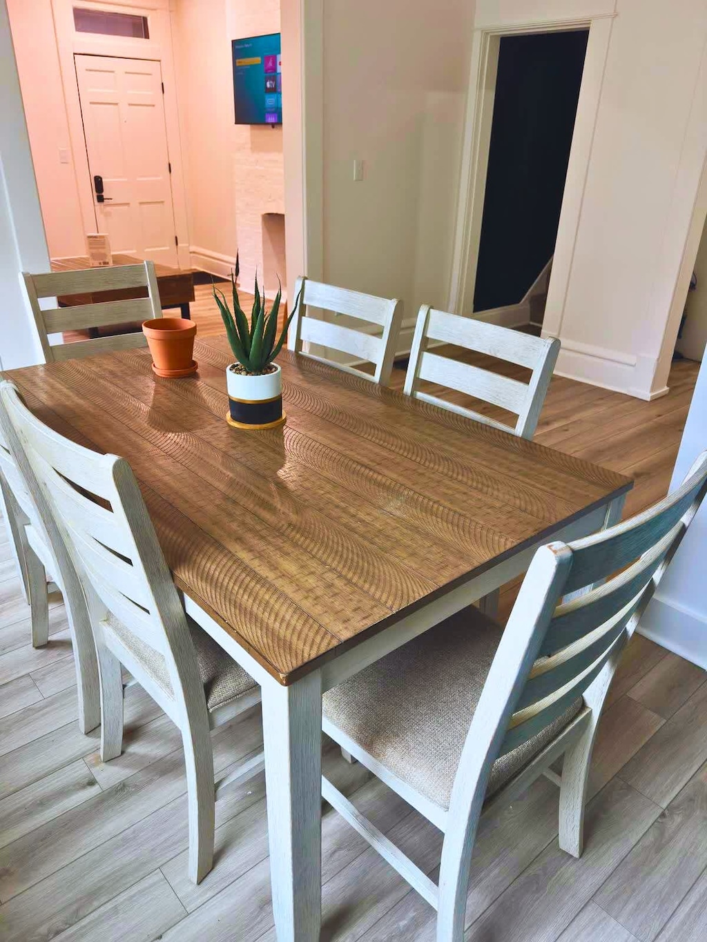 Enjoy a meal in our inviting dining area at Jungle House Airbnb, featuring a stylish wooden table and vibrant yellow chairs  Your perfect dining space in Short North Columbus