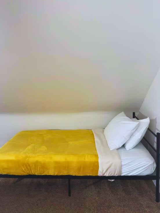"Experience the elegance of our modern bedroom at Jungle House Airbnb complete with a sleek wooden vanity and cozy ambiance  Your perfect retreat in Short North Columbus!